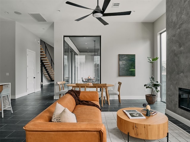 412 Kemp St, Austin, TX 78741 - living area with stairway, a ceiling fan, a high end fireplace, and recessed lighting