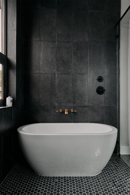 412 Kemp St, Austin, TX 78741 - full bath with tile walls, a soaking tub, and tile patterned flooring