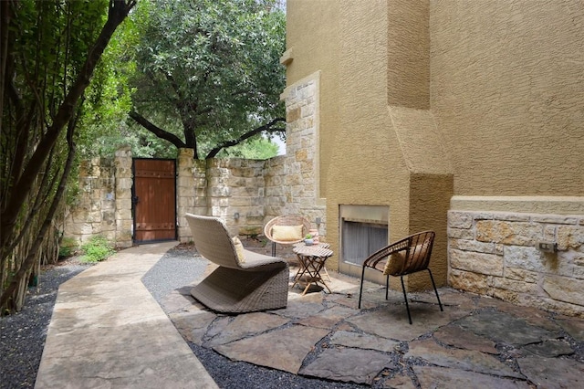 3406 Menchaca Rd Unit 14, Austin, TX 78704 - view of patio featuring an outdoor stone fireplace and a gate