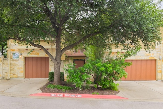3406 Menchaca Rd Unit 14, Austin, TX 78704 - obstructed view of property with driveway and stone siding