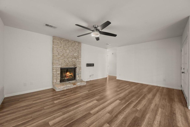 7604 Beinville Cv, Austin, TX 78749 - unfurnished living room with ceiling fan, wood finished floors, and a fireplace