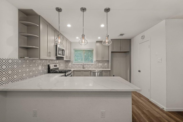 7604 Beinville Cv, Austin, TX 78749 - kitchen featuring appliances with stainless steel finishes, open shelves, gray cabinets, dark wood finished floors, and recessed lighting