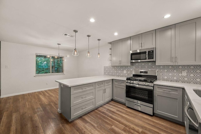 7604 Beinville Cv, Austin, TX 78749 - kitchen with appliances with stainless steel finishes, gray cabinetry, a peninsula, decorative backsplash, and recessed lighting