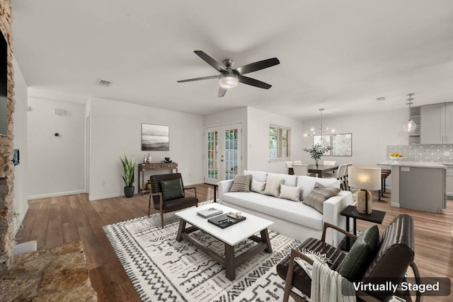 7604 Beinville Cv, Austin, TX 78749 - living area with a ceiling fan, light wood-style flooring, and a chandelier