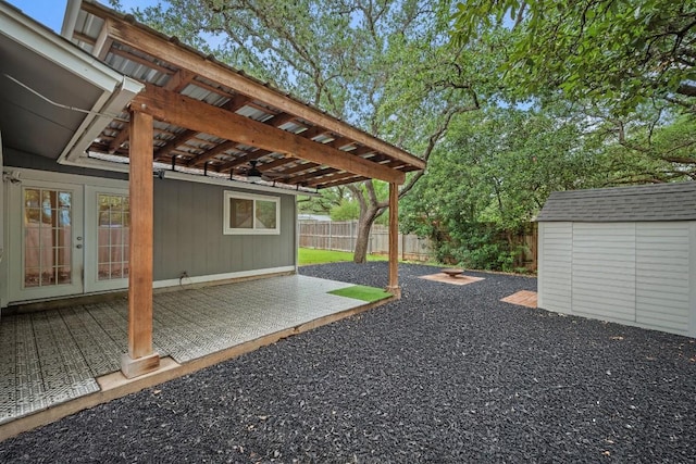 7604 Beinville Cv, Austin, TX 78749 - fenced backyard featuring french doors, a storage unit, and a patio area
