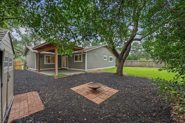 7604 Beinville Cv, Austin, TX 78749 - back of house with a patio, a fenced backyard, and a fire pit