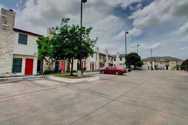 6900 E Riverside Dr Unit 8, Austin, TX 78741 - view of concrete road with street lights and a residential view
