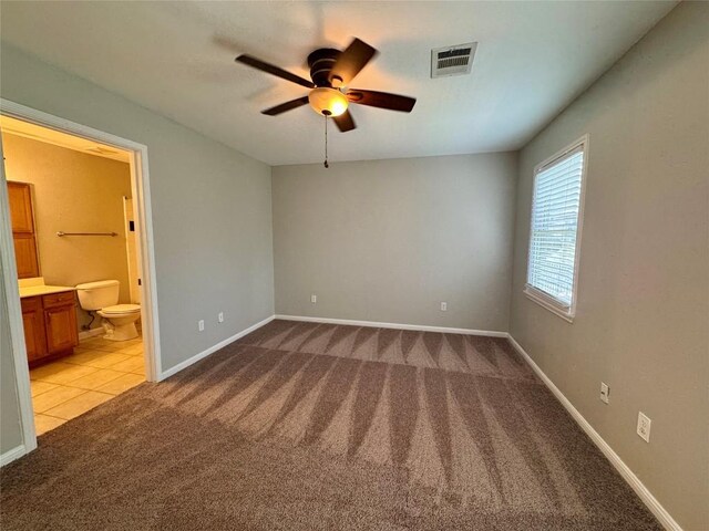 6900 E Riverside Dr Unit 8, Austin, TX 78741 - unfurnished bedroom featuring carpet flooring, ensuite bath, and a ceiling fan