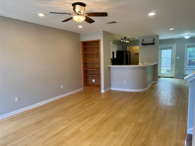 6900 E Riverside Dr Unit 8, Austin, TX 78741 - unfurnished living room with a ceiling fan, light wood finished floors, and recessed lighting
