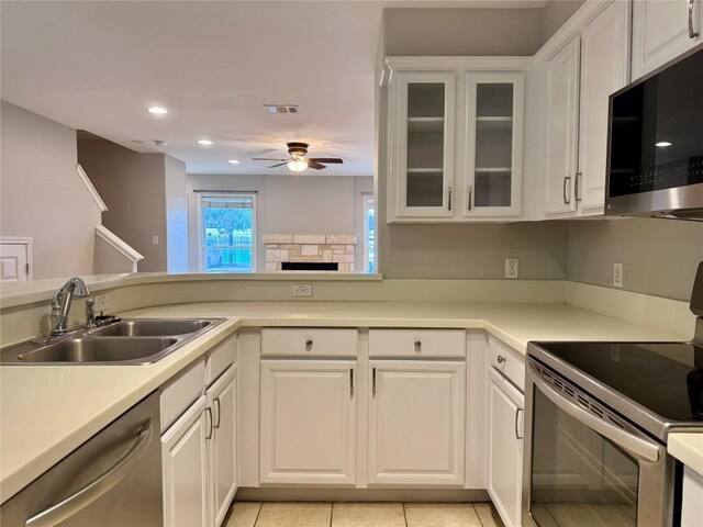 6900 E Riverside Dr Unit 8, Austin, TX 78741 - kitchen featuring stainless steel appliances, ceiling fan, white cabinets, light countertops, and recessed lighting