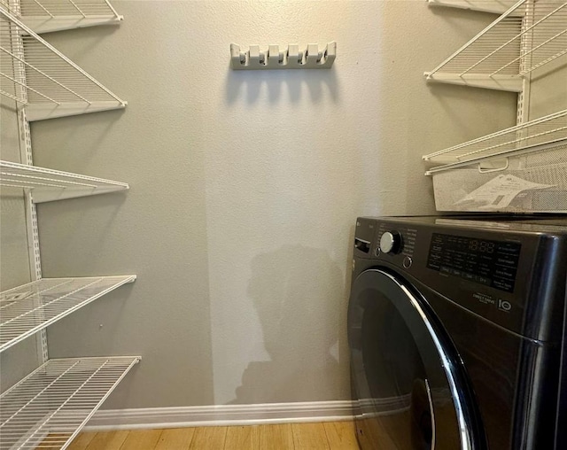 6900 E Riverside Dr Unit 8, Austin, TX 78741 - laundry area featuring washer / dryer and wood finished floors