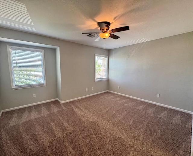 6900 E Riverside Dr Unit 8, Austin, TX 78741 - empty room featuring a ceiling fan and dark colored carpet