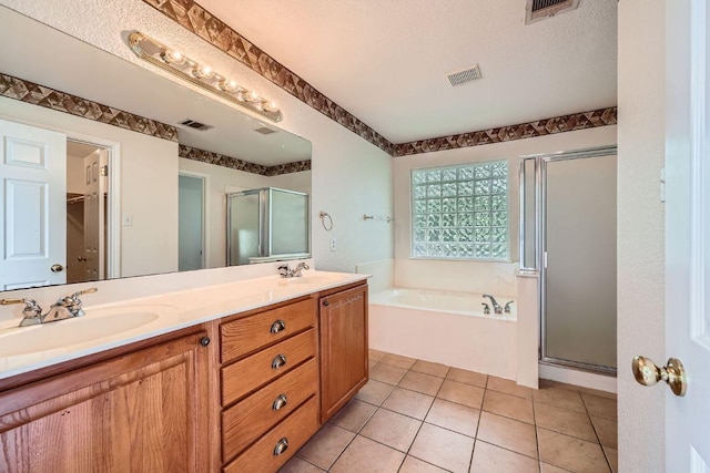 1506 Willow Bluff Dr, Pflugerville, TX 78660 - bathroom featuring a stall shower, a bath, double vanity, and a walk in closet