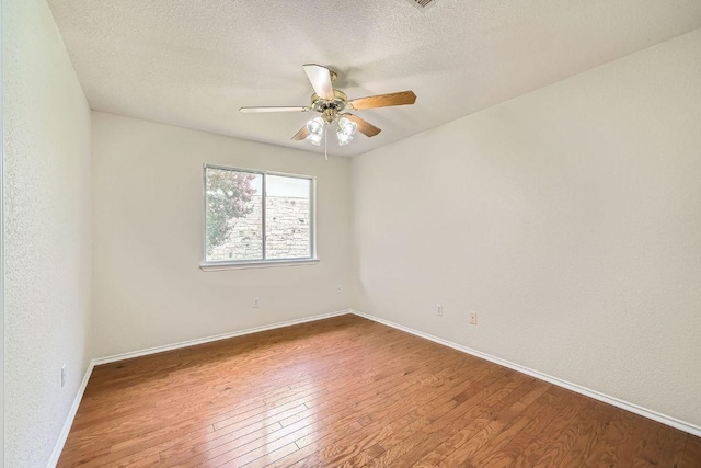 1506 Willow Bluff Dr, Pflugerville, TX 78660 - empty room with a ceiling fan, hardwood / wood-style floors, and a textured ceiling
