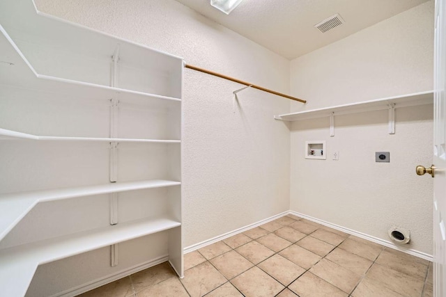 1506 Willow Bluff Dr, Pflugerville, TX 78660 - laundry room with washer hookup, electric dryer hookup, and tile patterned flooring