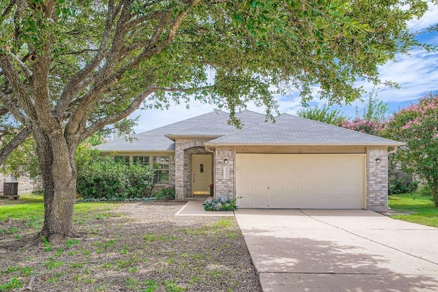 1506 Willow Bluff Dr, Pflugerville, TX 78660 - view of front of home with a garage, concrete driveway, and roof with shingles