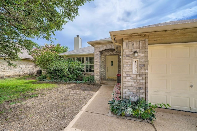 1506 Willow Bluff Dr, Pflugerville, TX 78660 - property entrance with a chimney, stone siding, a garage, and roof with shingles