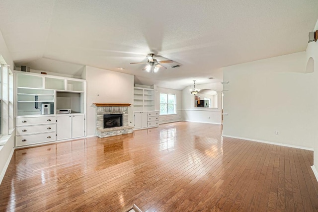 1506 Willow Bluff Dr, Pflugerville, TX 78660 - unfurnished living room with lofted ceiling, a ceiling fan, a fireplace, and hardwood / wood-style floors