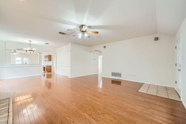 1506 Willow Bluff Dr, Pflugerville, TX 78660 - unfurnished living room featuring ceiling fan, arched walkways, wood finished floors, and lofted ceiling