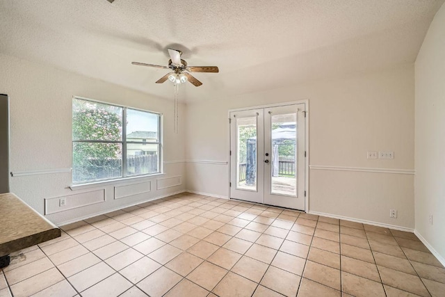 1506 Willow Bluff Dr, Pflugerville, TX 78660 - empty room featuring plenty of natural light, french doors, ceiling fan, light tile patterned floors, and a textured ceiling