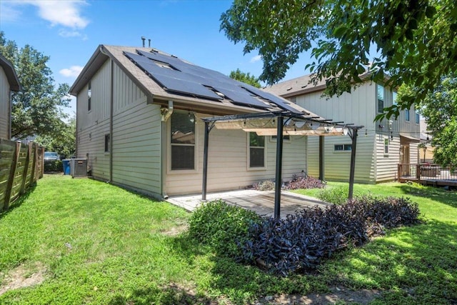 2101 Rivers Edge Way Unit 17, Austin, TX 78741 - rear view of property featuring roof mounted solar panels, a pergola, a patio, and board and batten siding