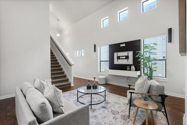 2101 Rivers Edge Way Unit 17, Austin, TX 78741 - living room featuring a towering ceiling, stairway, and wood finished floors