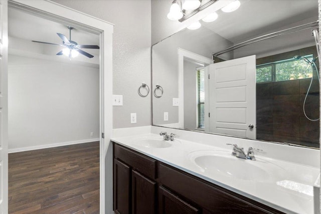 2101 Rivers Edge Way Unit 17, Austin, TX 78741 - full bathroom featuring wood finished floors, double vanity, ceiling fan, and tiled shower