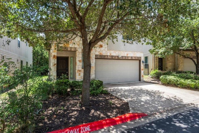 2101 Rivers Edge Way Unit 17, Austin, TX 78741 - view of front of property featuring stone siding and concrete driveway