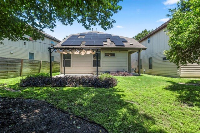 2101 Rivers Edge Way Unit 17, Austin, TX 78741 - rear view of property with roof mounted solar panels and a patio
