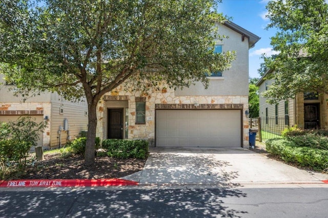 2101 Rivers Edge Way Unit 17, Austin, TX 78741 - view of front of property with stone siding, driveway, and an attached garage