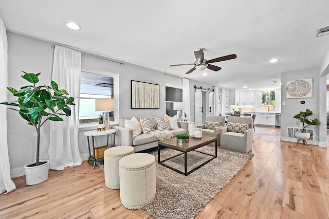 2306 Westoak Dr, Austin, TX 78704 - living area featuring a ceiling fan, light wood finished floors, a barn door, and recessed lighting