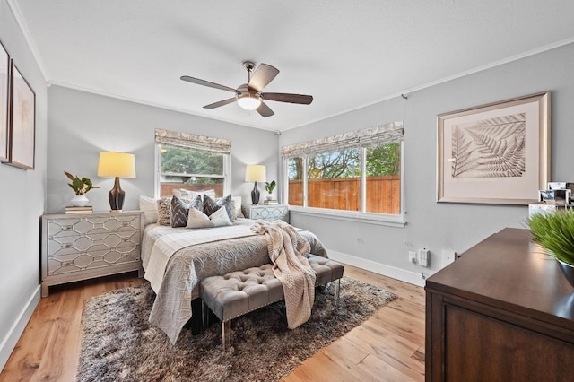 2306 Westoak Dr, Austin, TX 78704 - bedroom with light wood-style flooring, multiple windows, crown molding, and a ceiling fan