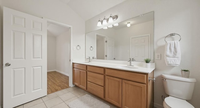 5809 Needle Nook Ct, Austin, TX 78744 - bathroom featuring tile patterned flooring, double vanity, and lofted ceiling
