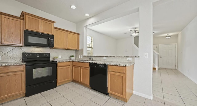 5809 Needle Nook Ct, Austin, TX 78744 - kitchen featuring black appliances, light tile patterned flooring, decorative backsplash, light stone countertops, and a ceiling fan