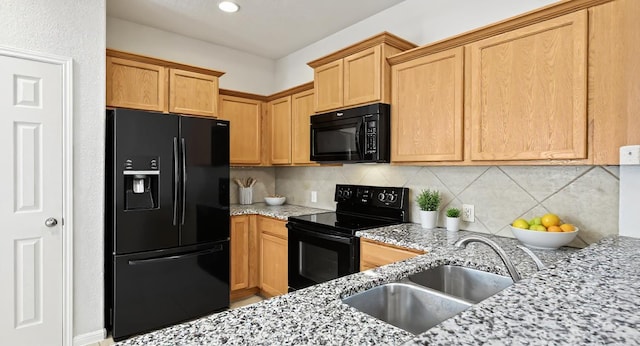 5809 Needle Nook Ct, Austin, TX 78744 - kitchen featuring black appliances, light stone countertops, and backsplash