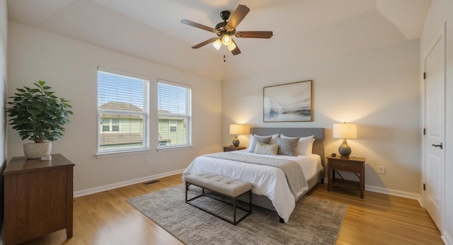 5809 Needle Nook Ct, Austin, TX 78744 - bedroom with light wood-style flooring, vaulted ceiling, and a ceiling fan