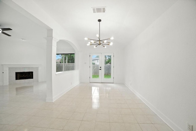 3013 Wavecrest Blvd, Austin, TX 78728 - entrance foyer with a chandelier, a fireplace, french doors, light tile patterned floors, and arched walkways
