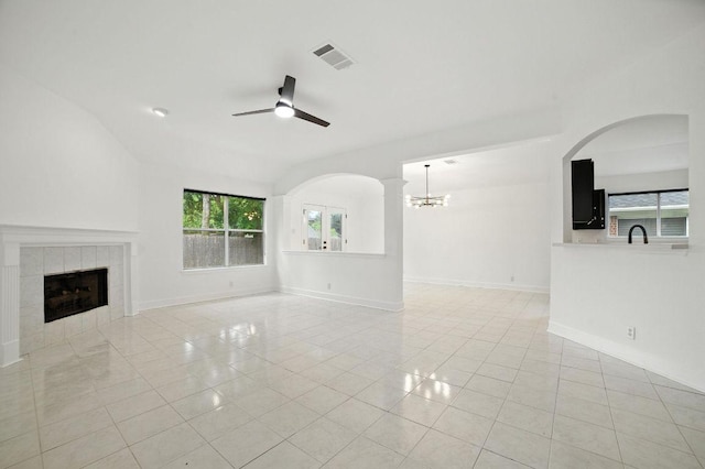 3013 Wavecrest Blvd, Austin, TX 78728 - unfurnished living room featuring plenty of natural light, ceiling fan, light tile patterned floors, and a tile fireplace