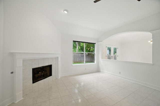 3013 Wavecrest Blvd, Austin, TX 78728 - unfurnished living room featuring lofted ceiling, a tile fireplace, tile patterned floors, and arched walkways