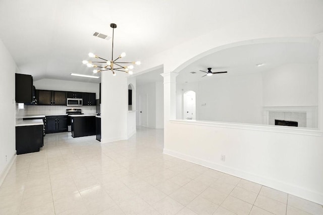 3013 Wavecrest Blvd, Austin, TX 78728 - unfurnished living room with arched walkways, ceiling fan, lofted ceiling, a chandelier, and light tile patterned floors