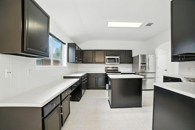 3013 Wavecrest Blvd, Austin, TX 78728 - kitchen with appliances with stainless steel finishes, decorative backsplash, vaulted ceiling, light countertops, and light tile patterned flooring