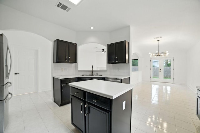 3013 Wavecrest Blvd, Austin, TX 78728 - kitchen featuring arched walkways, stainless steel appliances, french doors, light tile patterned floors, and recessed lighting