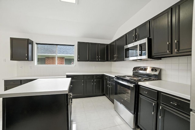 3013 Wavecrest Blvd, Austin, TX 78728 - kitchen featuring appliances with stainless steel finishes, light countertops, backsplash, lofted ceiling, and dark cabinets