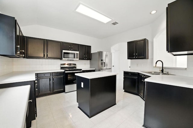 3013 Wavecrest Blvd, Austin, TX 78728 - kitchen with appliances with stainless steel finishes, decorative backsplash, light countertops, and a center island