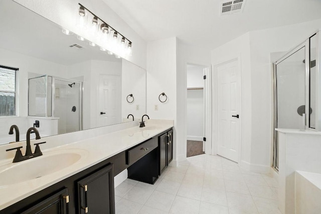 3013 Wavecrest Blvd, Austin, TX 78728 - full bathroom featuring a stall shower, double vanity, tile patterned floors, and a spacious closet
