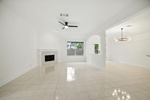 3013 Wavecrest Blvd, Austin, TX 78728 - unfurnished living room with a chandelier, light tile patterned floors, a tiled fireplace, a ceiling fan, and vaulted ceiling