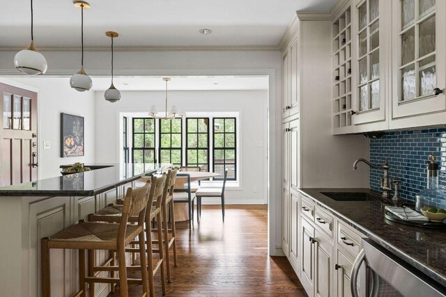 1118 Reagan Ter, Austin, TX 78704 - bar with dark wood-type flooring, dishwashing machine, decorative light fixtures, and crown molding