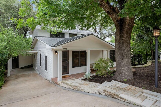 1118 Reagan Ter, Austin, TX 78704 - view of front of property featuring concrete driveway and a metal roof