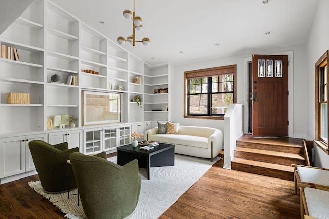 1118 Reagan Ter, Austin, TX 78704 - living area with wood finished floors, built in shelves, and a chandelier