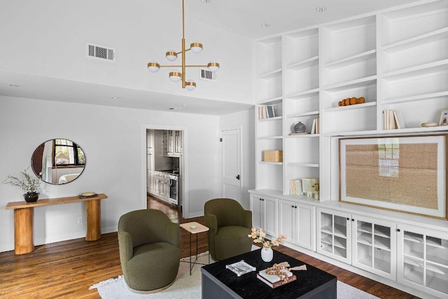 1118 Reagan Ter, Austin, TX 78704 - living area with wood finished floors, a high ceiling, and a chandelier